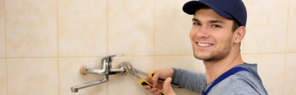 Plumber fixing bathroom sink doing emergency plumbing Calgary, AB