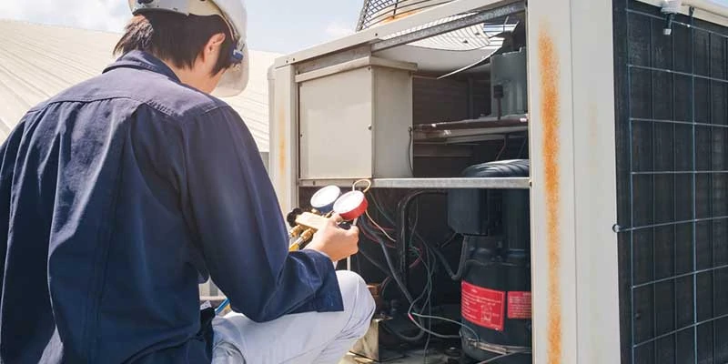 A technician doing air conditioning installation in Calgary, AB