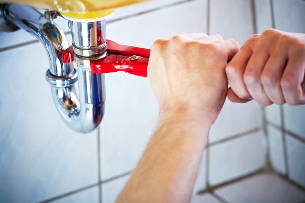 A plumber fixing a pipe plumbing in Calgary, AB