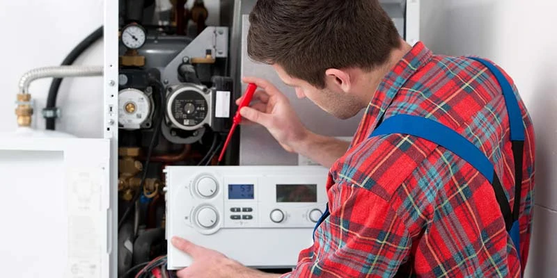 Technician doing water heater installation in Calgary, AB