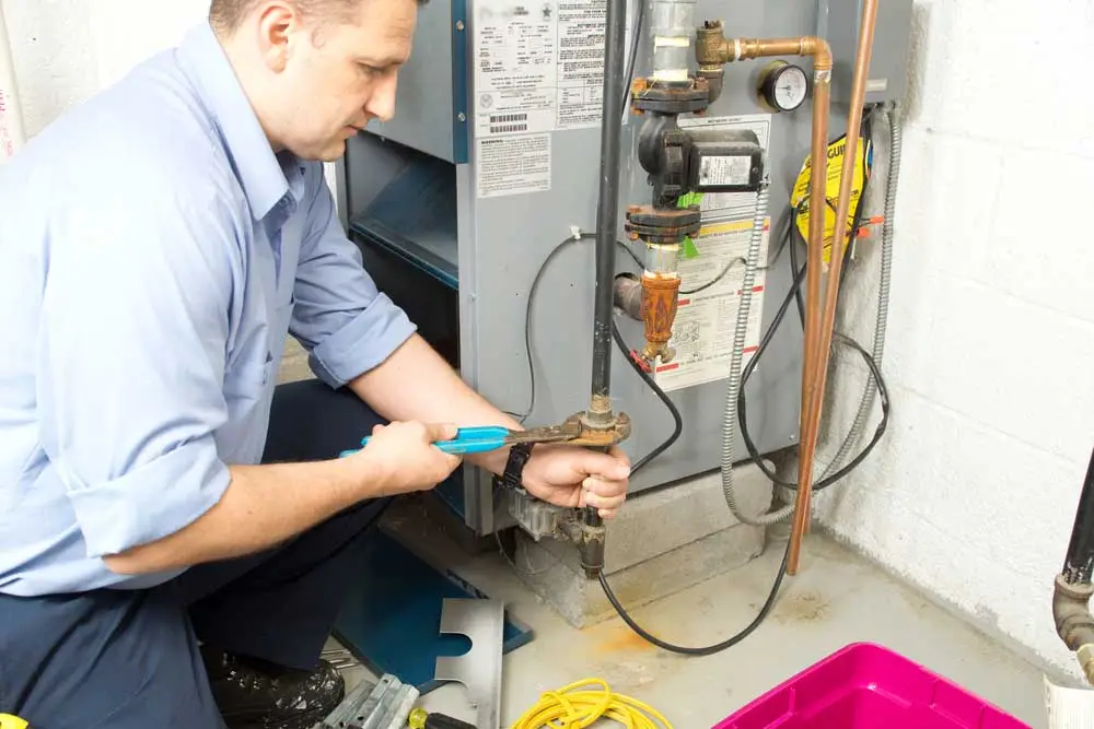 technician fixing gas furnace