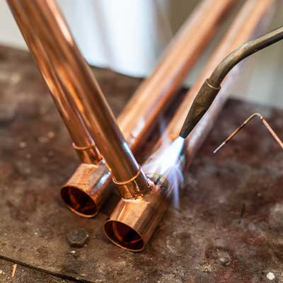 Copper pipe being fixed by emergency plumber Calgary, AB
