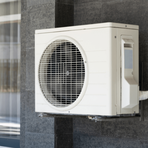 Outdoor unit of a split system air conditioner mounted on a wall.