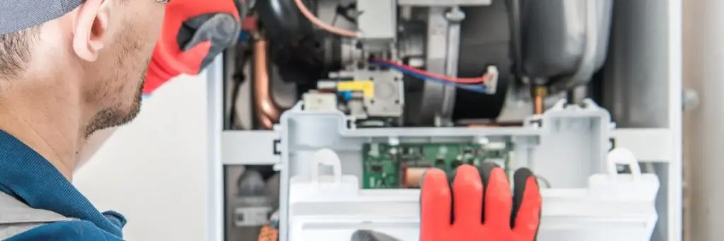 Plumber doing furnace installation in Calgary