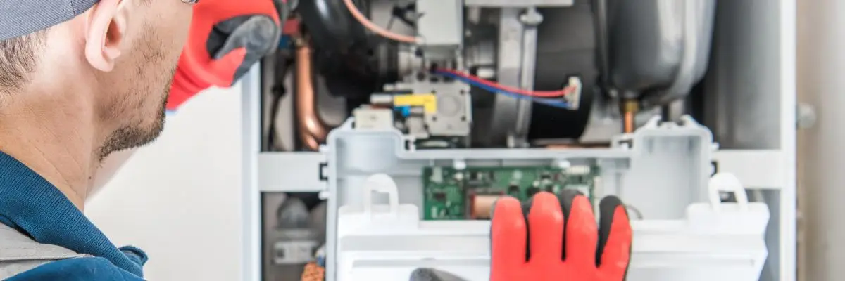 Plumber doing furnace installation in Calgary