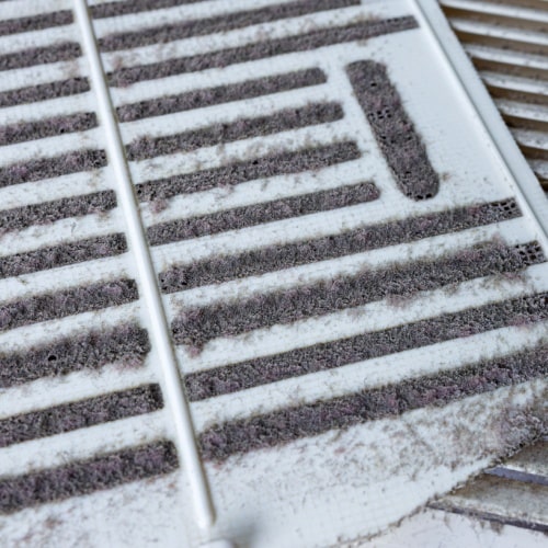 Close-up of a dusty and dirty HVAC vent cover in Calgary.